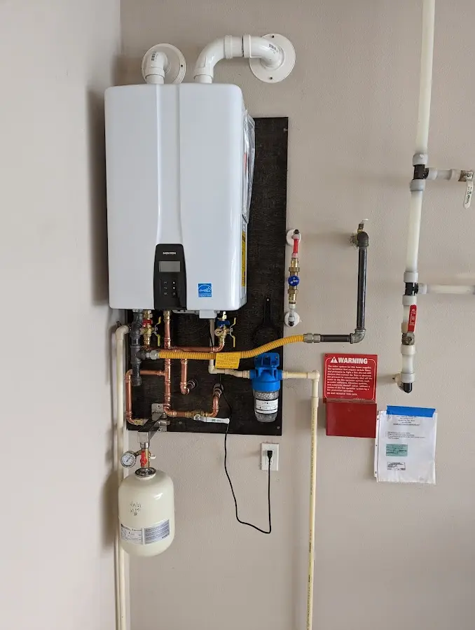 Professional plumber installing copper piping in a Portland home